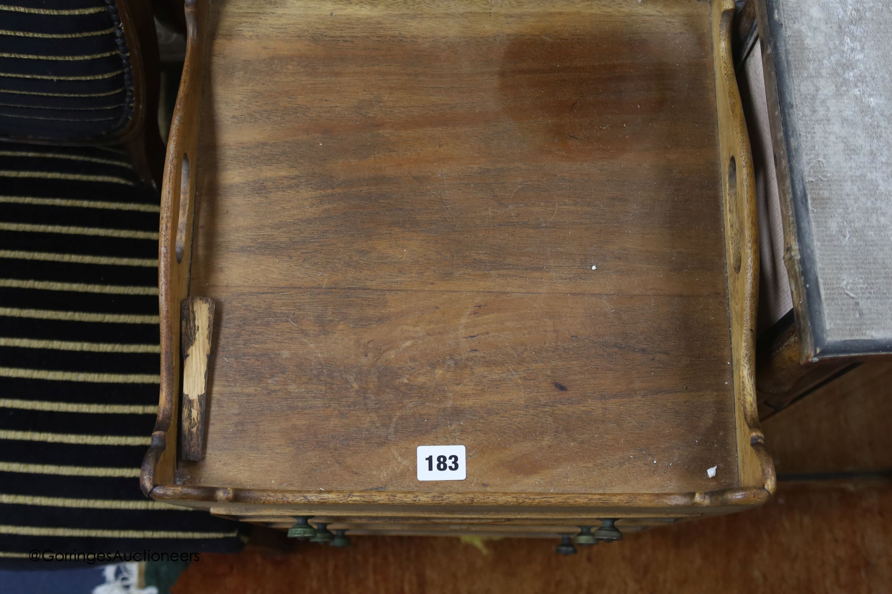 An early 19th century mahogany bedside chest of three drawers